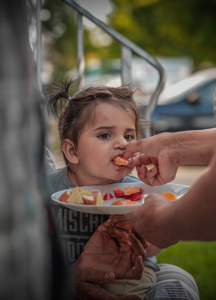 Close-up Of Feeding A Girl