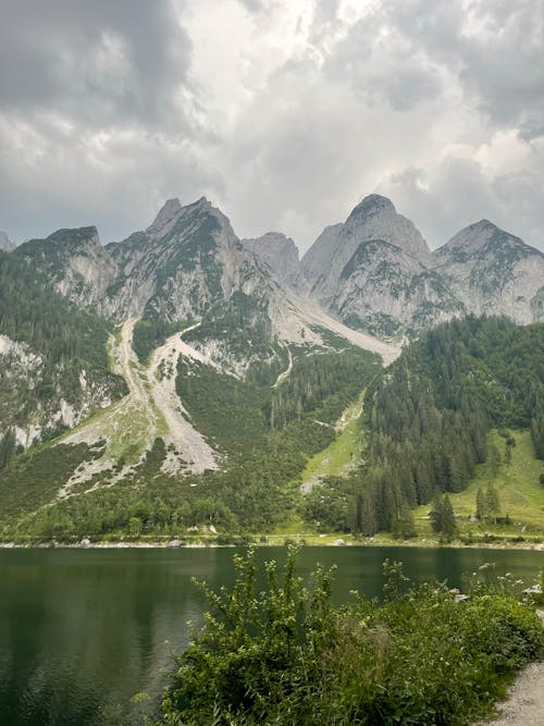 Lake and Mountain Under Cloudy Sky