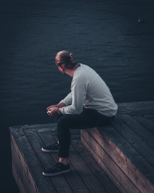 Man Sitting By The Lake