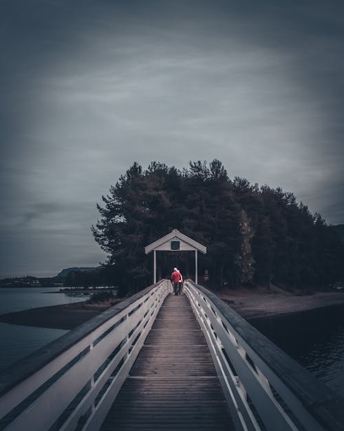 Couple Walking Over A Bridge