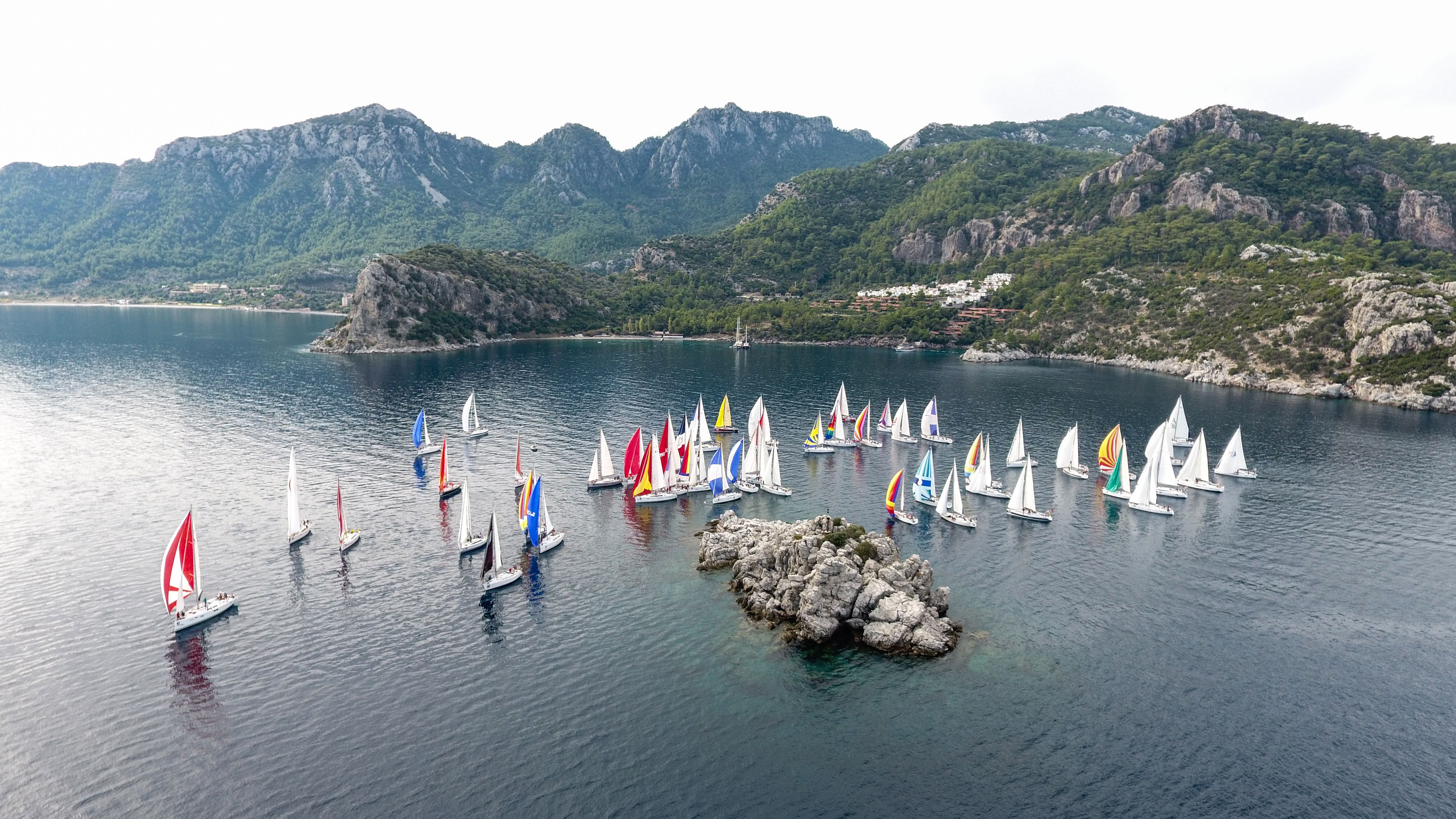 Best Full Day All Inclusive Boat Ride and Foam Party Review: My Unforgettable Turkish Riviera Adventure Review 2026 - Aerial view of vibrant sailing boats near scenic Marmaris, Turkey coastline.