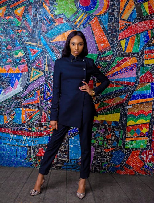 A Woman in Black Long Sleeves and Pants Standing Near the Wall with Graffiti