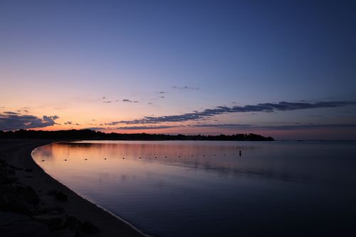 Free Calm ocean view at sunset in Stamford, CT with a colorful sky. Stock Photo