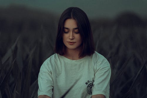 A Woman in White Shirt Looking Down