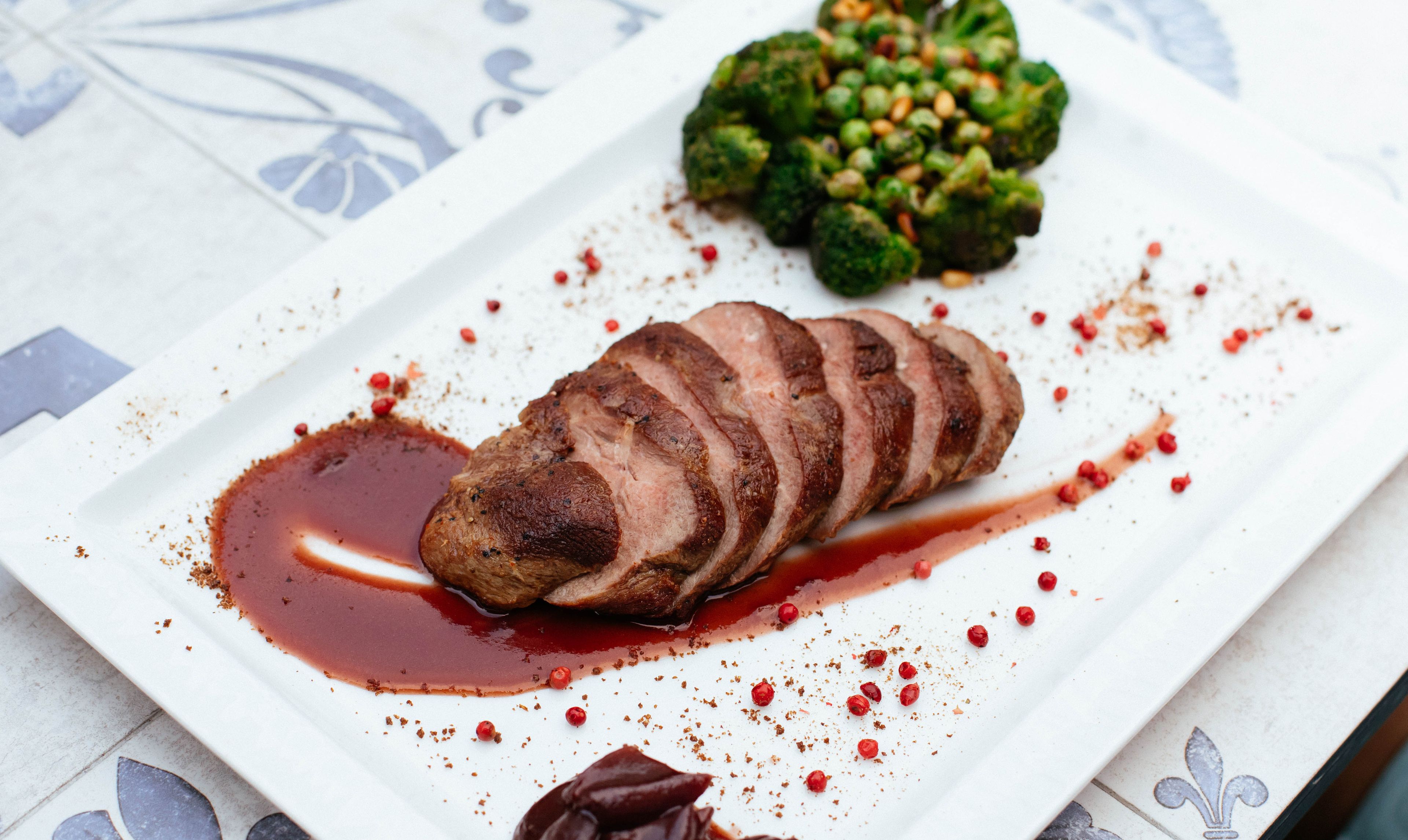Sliced meat fanned over a red-wine jus
