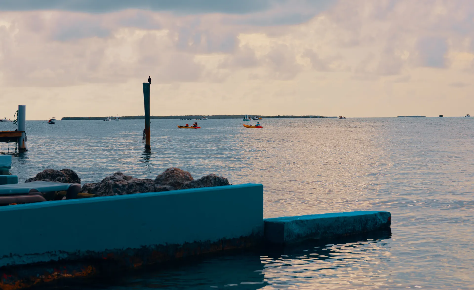 Scene of kayakers enjoying a sunset paddle on the ocean waters. Scene of kayakers enjoying a sunset paddle on the ocean waters.