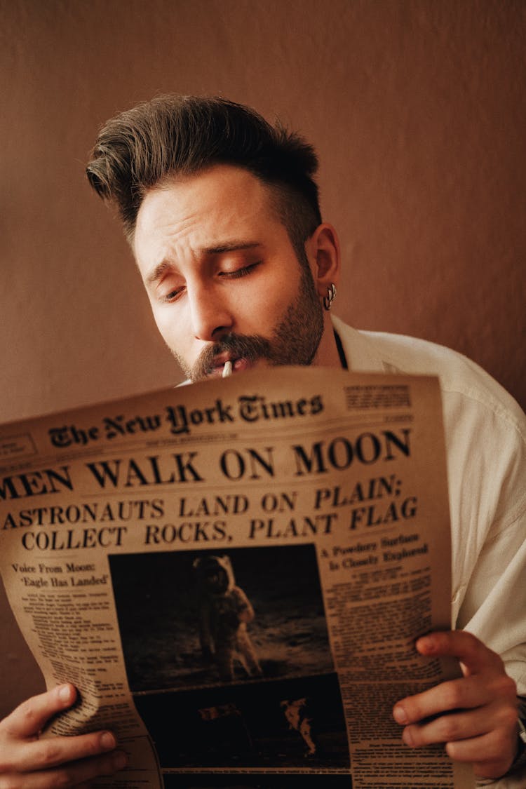 Young Man Reading Newspaper