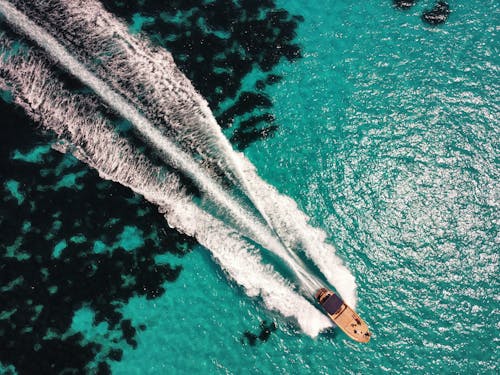 Top View of a a Boat Sailing in a with Turquoise Water