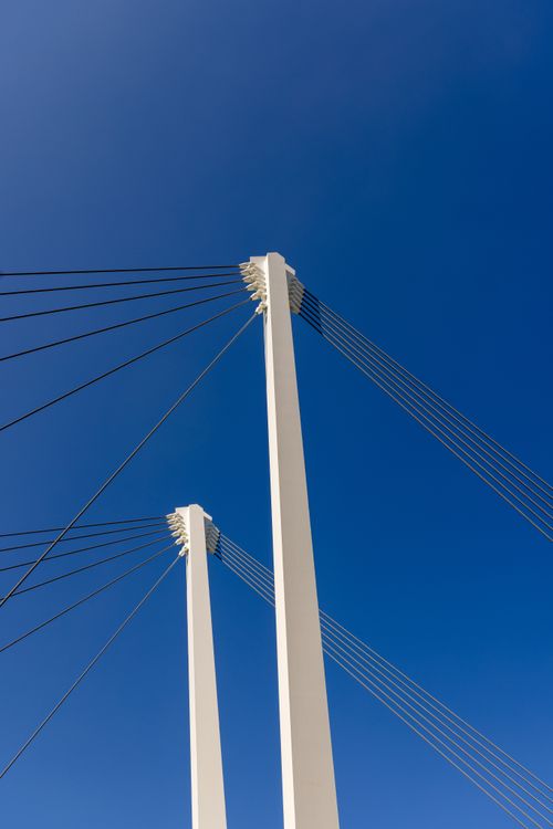 Free Low angle shot of a modern suspension bridge under a clear blue sky in Revere, MA. Stock Photo