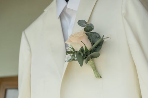 A Boutonniere Hanging on the White Suit 