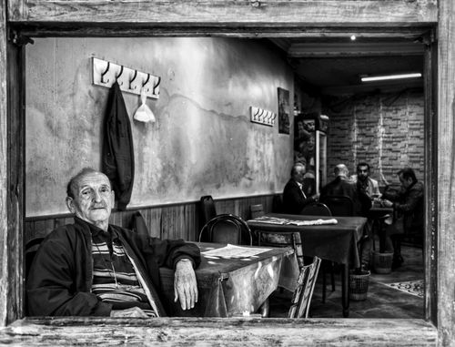 Free Monochrome scene of an elderly man sitting in an Istanbul café. Stock Photo