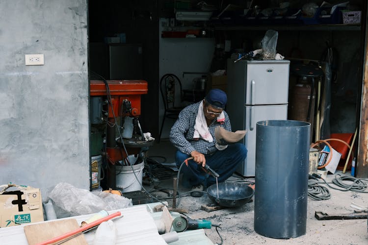 A Man Sitting In A Garage