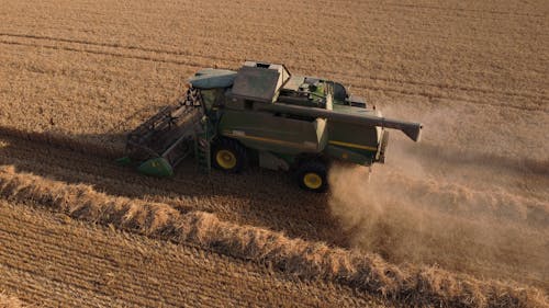 Aerial View of a Combine Harvester on a Crop 