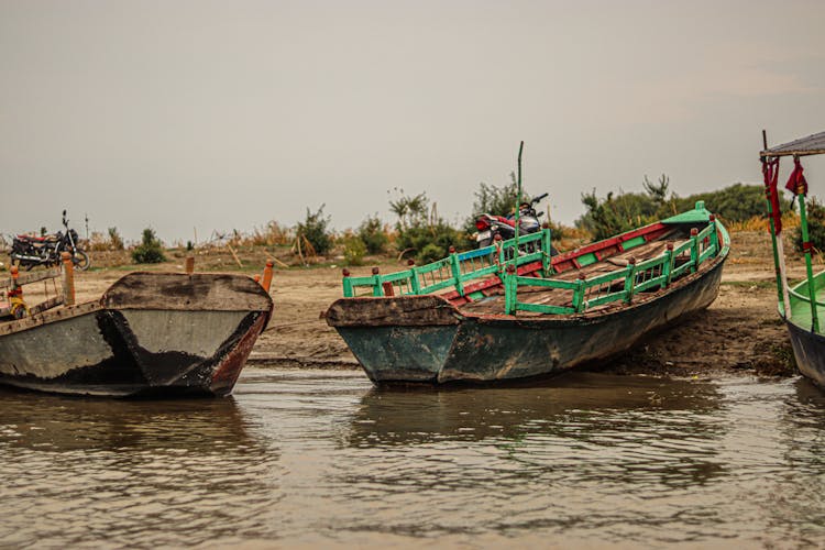 Old Wooden Boats Docked On The Shore