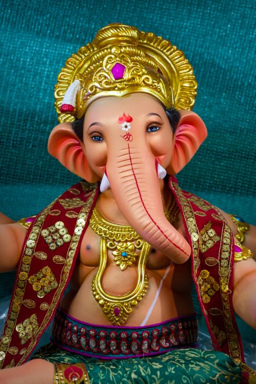 Free Intricate Ganesh figurine adorned in vibrant attire, symbolizing Hindu mythology, Mumbai. Stock Photo