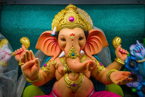 Free Colorful Ganesh statue with detailed ornaments, perfect for religious and cultural depictions. Stock Photo
