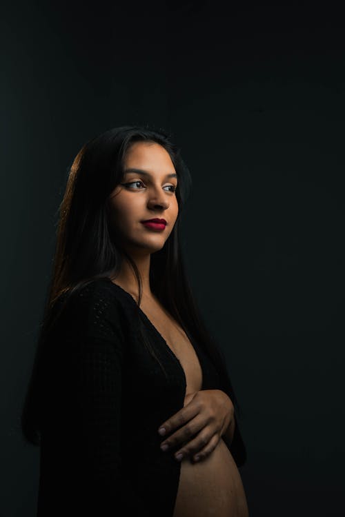 Free A Beautiful Woman in Black Cardigan Looking Afar Stock Photo