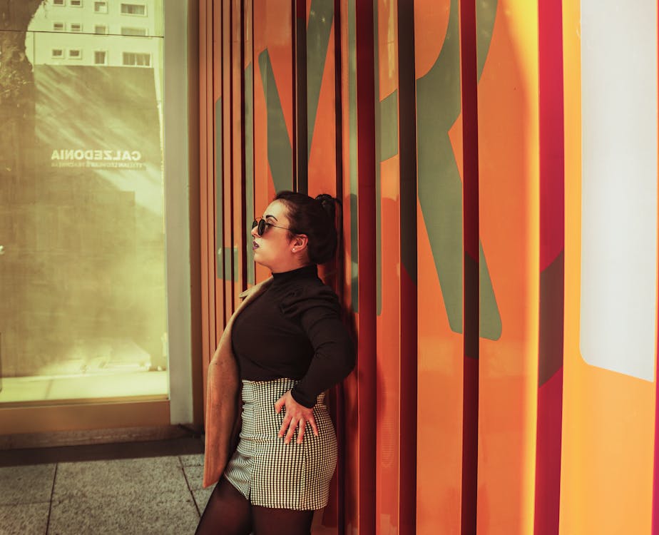 Woman in Black Long Sleeves Leaning on a Wall