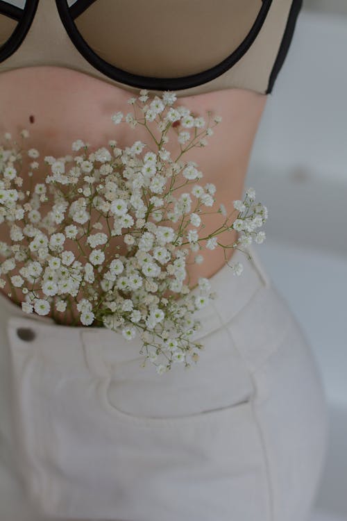 Woman with White Flowers Beside Her Belly