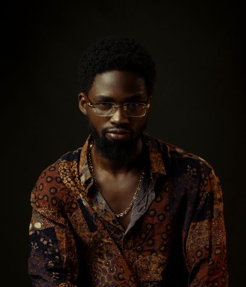 Free Portrait of an adult man with a beard and eyeglasses wearing a colorful patterned shirt. Stock Photo