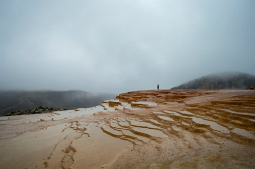 Foggy Landscape with a Person Standing on a Terraced Hill, Badab-e Surt, Iran