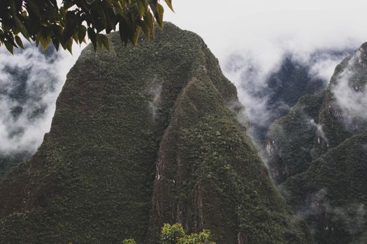 Scenic view of the lush green mountains surrounded by mist at Machu Picchu, Peru.