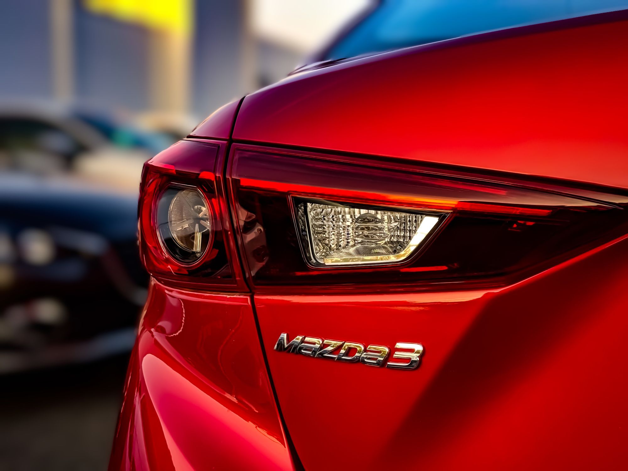 Close-Up Shot of a Red Car by Obi Onyeador is licensed with Pexels License Red Mazda 3