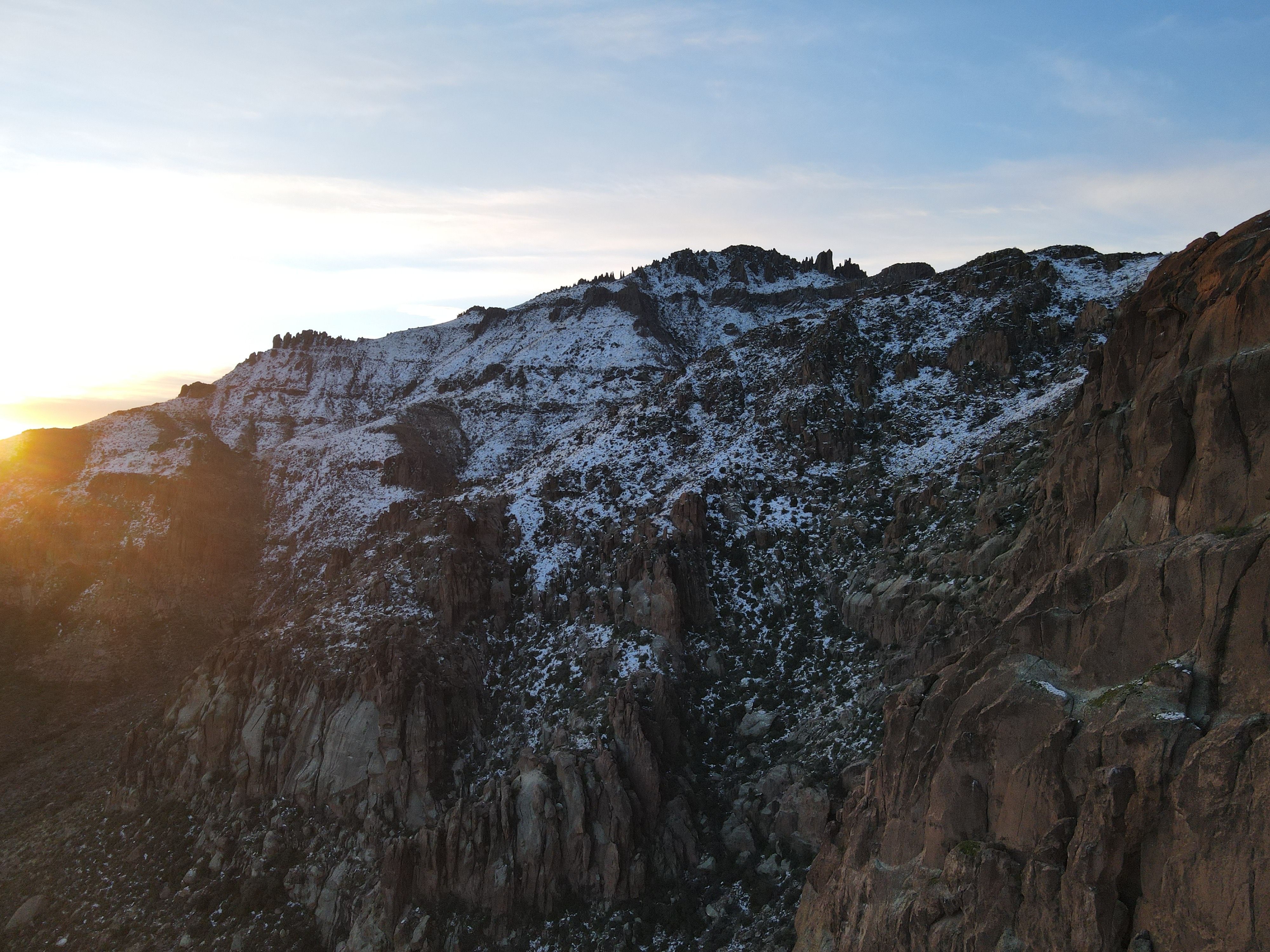 A Snow Covered Rocky Mountain during the Golden Hour · Free Stock Photo