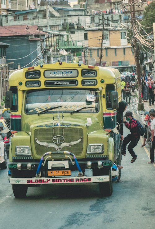 Man Hanging on the Side of the Bus