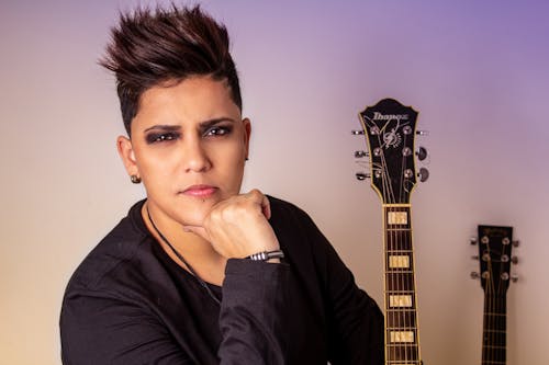 Woman Hands on Chin Beside Guitar