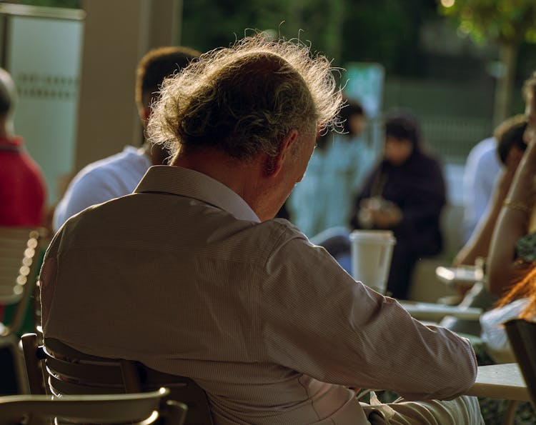 A Man Sitting On A Chair