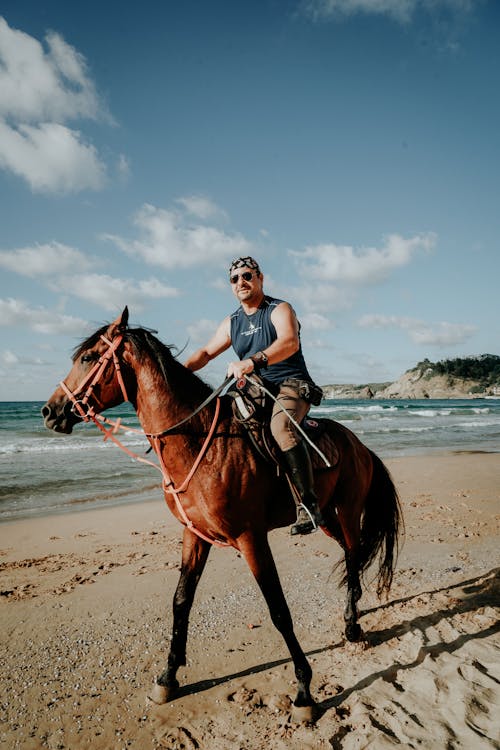 A Man Riding a Horse at the Beach 