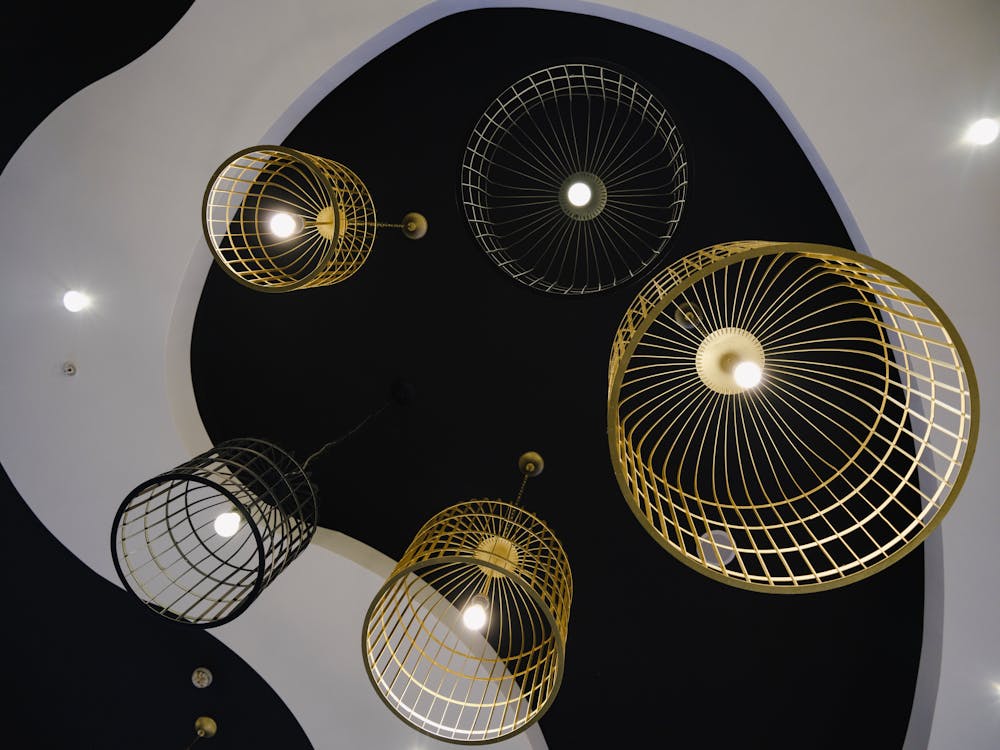 Artistic display of cage-like ceiling lights in a minimalist interior design.