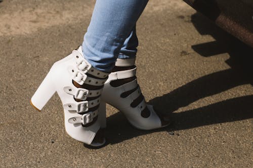 Free Person Showing Pair of White Peep-toe Chunky Heel Sandals Stock Photo