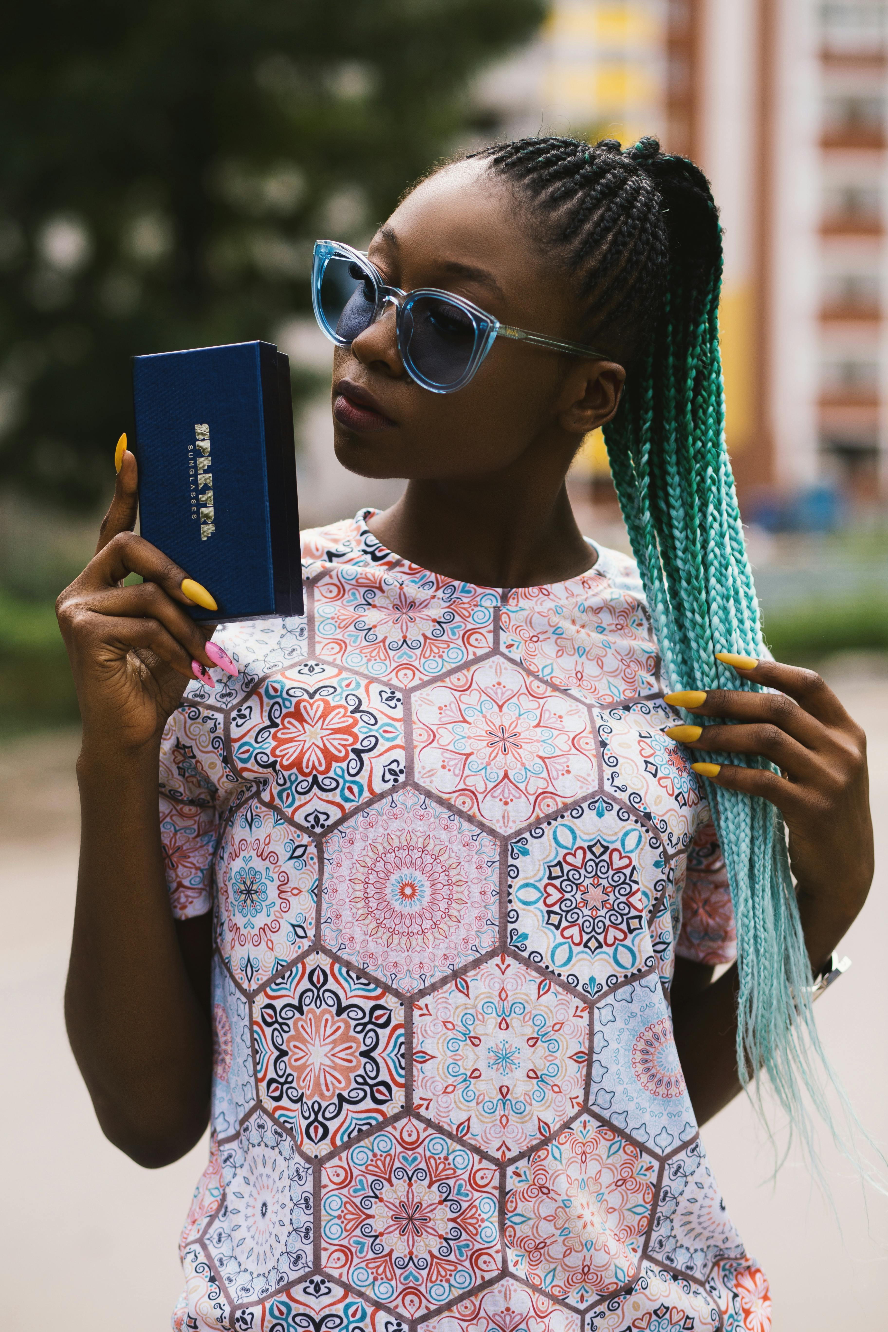 woman holding blue case with blue hair