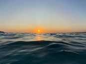 Capture the serene beauty of a golden hour sunset over the ocean waves, perfect for a calming ambiance.