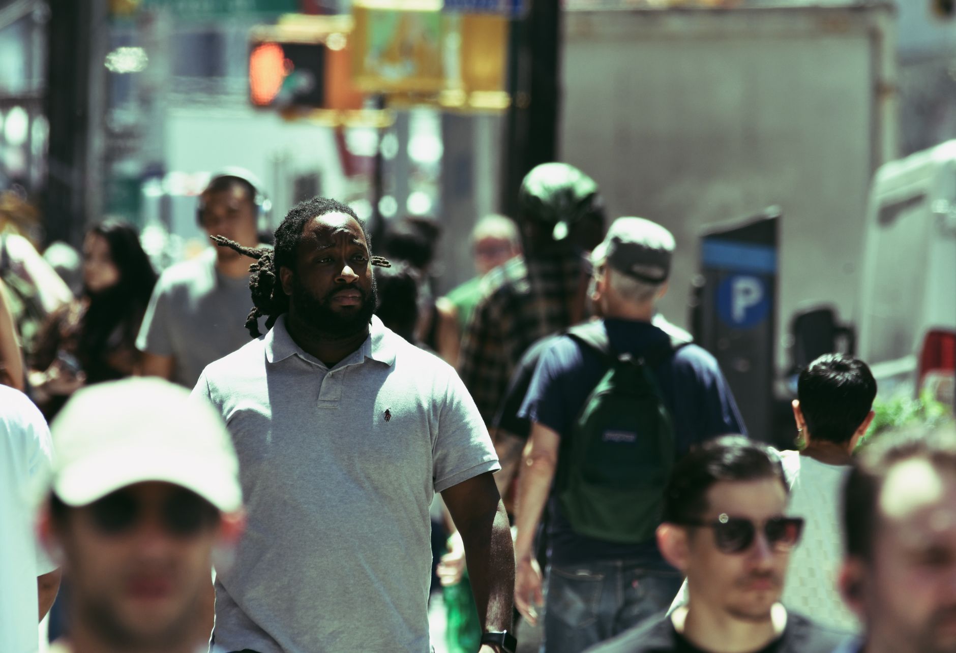 A bustling city street scene with diverse people walking in summer.