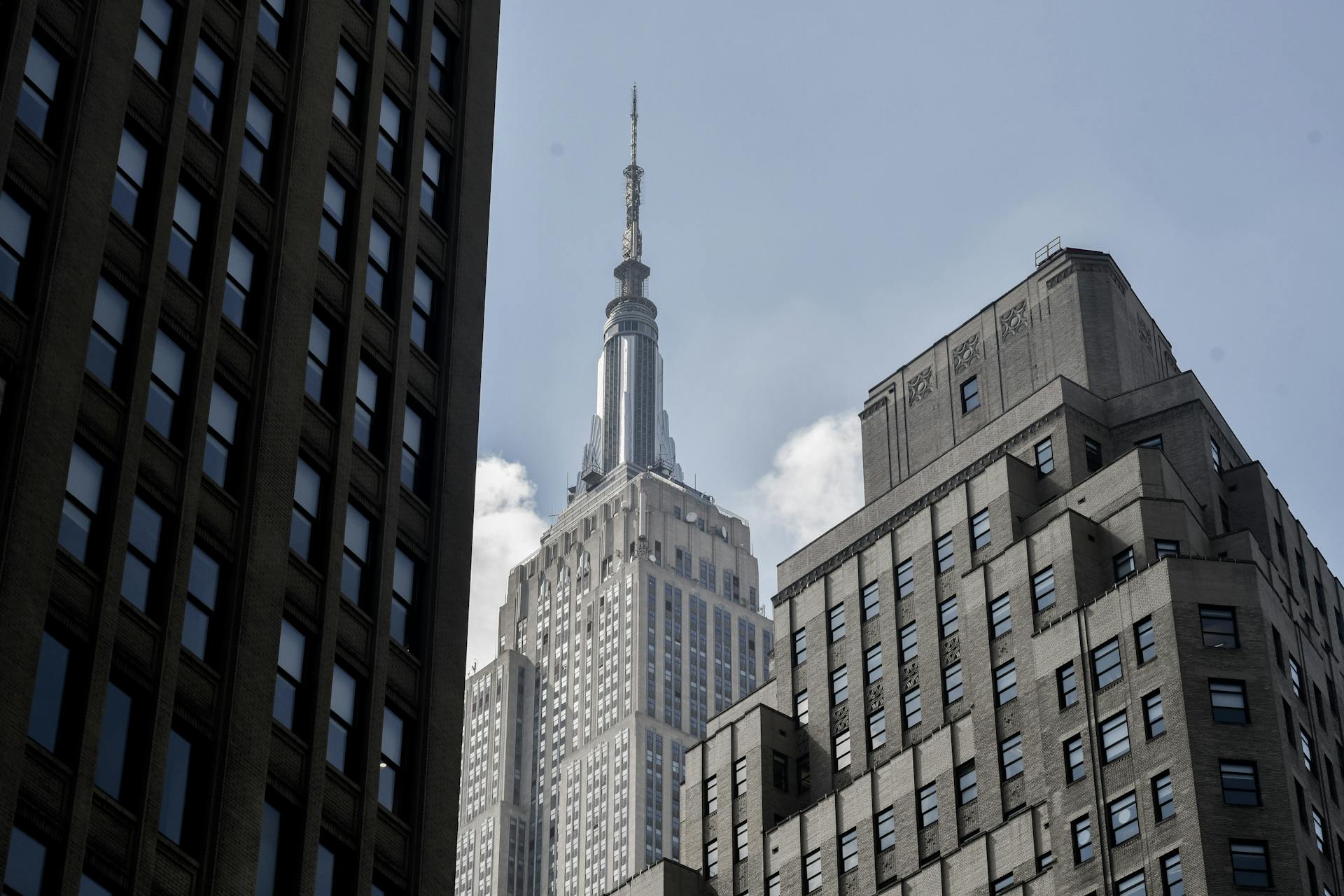 Stunning view of the Empire State Building framed by nearby skyscrapers in New York City.