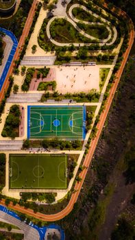 Drone shot of sports complex with basketball and soccer fields in Mexico City.