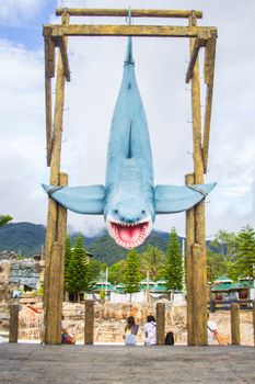 Massive shark statue at an outdoor amusement park, perfect for adventure and thrill seekers.