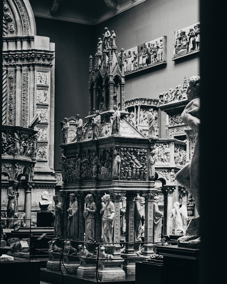 Grayscale Photo Of Statues Inside The Room