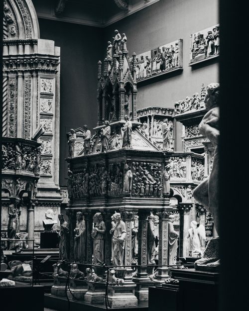 Free Explore intricate sculptures in a museum's tranquil grayscale setting. Stock Photo