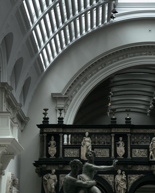 Free A refined view of classic sculptures under elegant arches in a renowned museum. Stock Photo