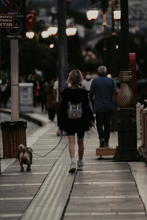 Back View of a Woman Walking with her Dog