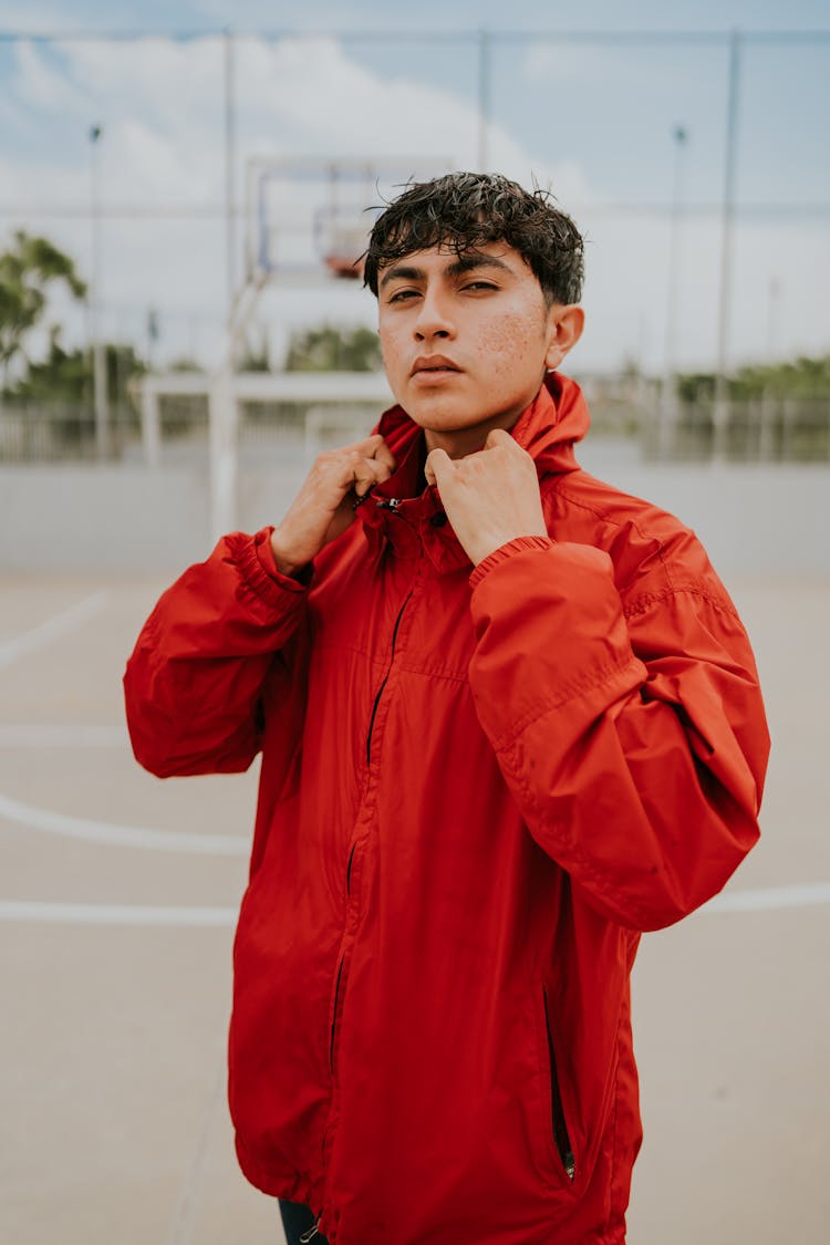 Man In Red Jacket Holding His Collar