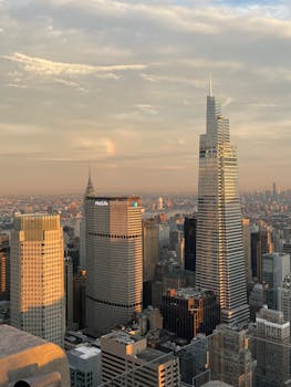 Stunning view of New York City's skyline featuring skyscrapers, including the MetLife Building, at sunset.