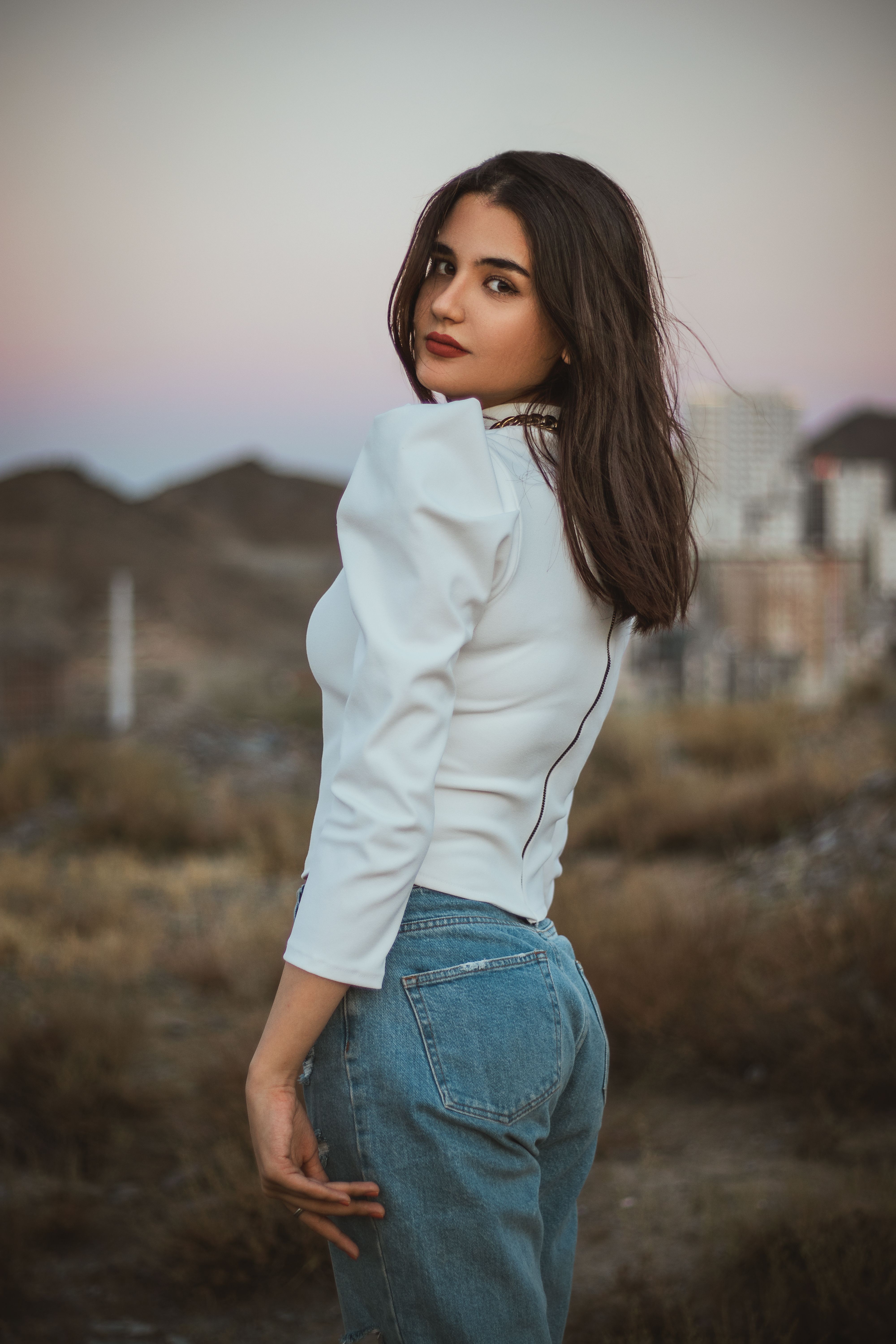 Woman in White Long Sleeve Shirt and Blue Denim Jeans · Free Stock Photo