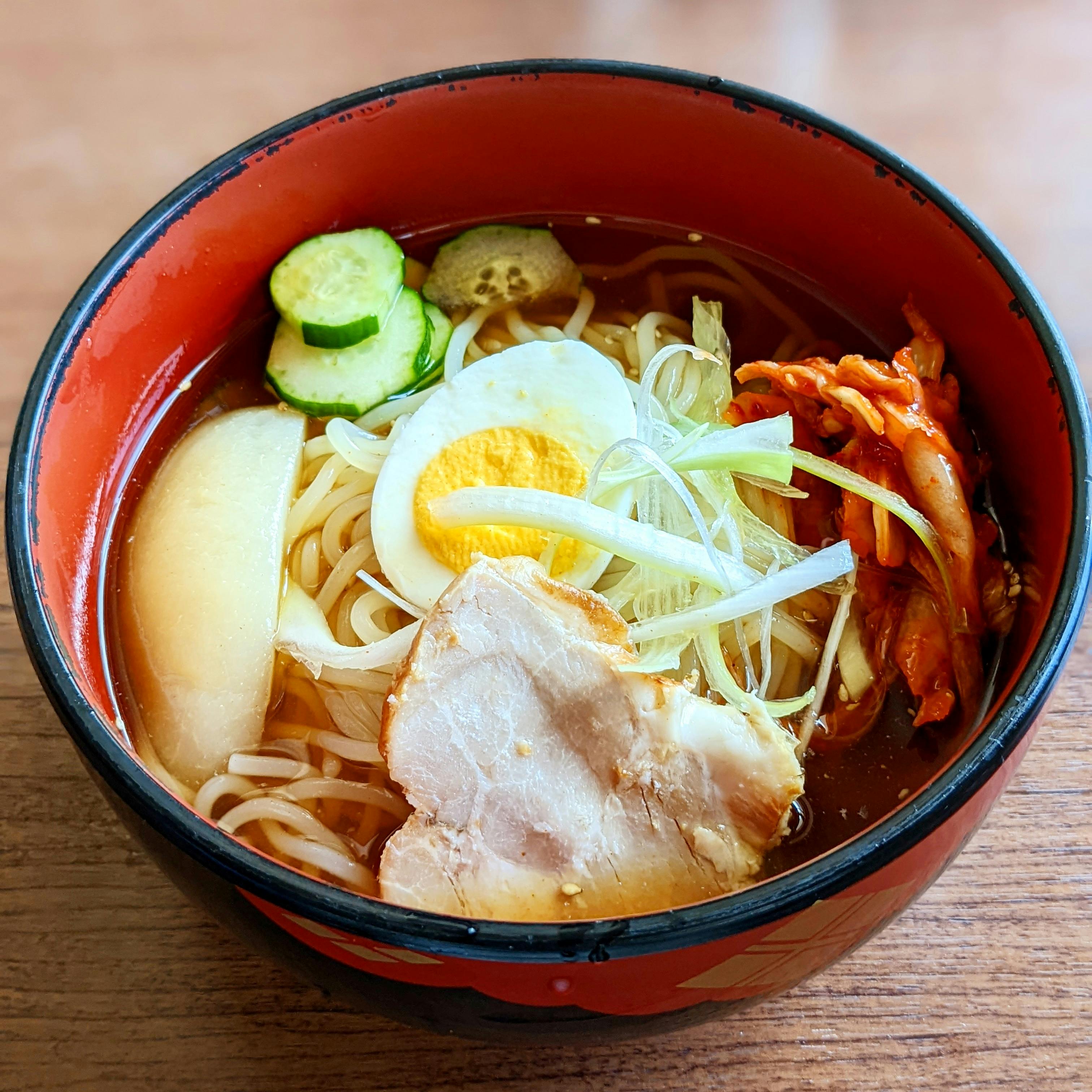 ramen in red ceramic bowl