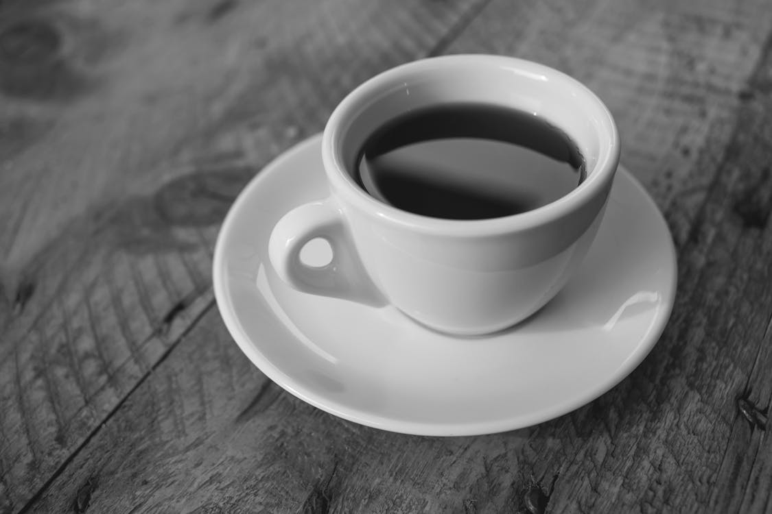 White Ceramic Cup Filled With Black Liquid