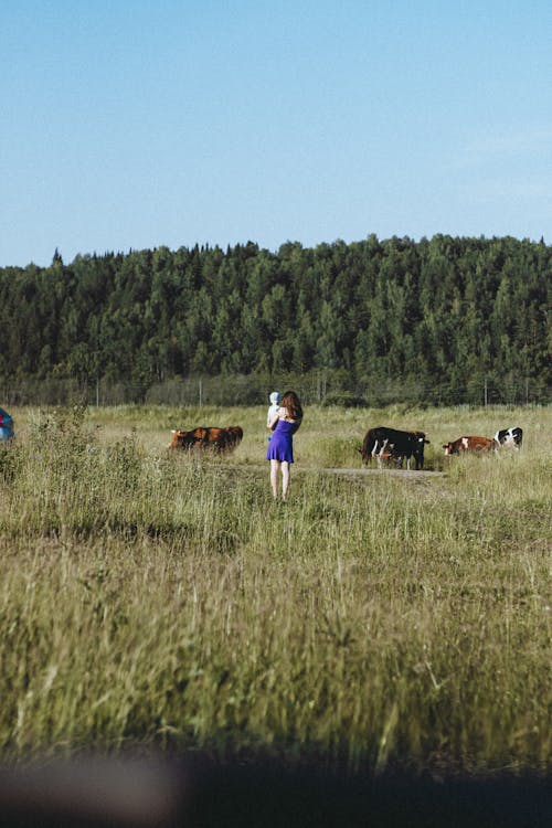 Woman in Blue Dress in a Farm Land